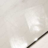 Close-up of Cecelia Gold glossy porcelain tile showing mirror-polished ivory marble surface with delicate golden vein detail and 9mm thickness