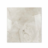 Marbella Gold glossy porcelain tile 120x120cm displayed on easel against luxury marble backdrop for UAE interior design