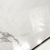Close-up of Statuario Krypton glossy porcelain tile showing mirror-polished white marble surface with intricate black vein clusters and 9mm thickness