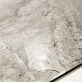 Close-up of Breccia Bianco glossy porcelain tile showing mirror-polished marble surface with detailed dark vein clusters and 9mm thickness.