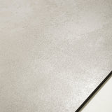 Meera Grey matte porcelain tile 120x120cm displayed on easel against luxury marble backdrop for UAE interior design