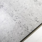 Close-up of Stonex Grey matte porcelain tile showing detailed pebble aggregate texture, natural stone effect, and 9mm thickness
