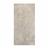Element Coach Smoke porcelain slab displayed on easel against luxury backdrop showing smoky grey natural stone surface with terrazzo-like texture for UAE interior design