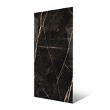 Black Daytona large format porcelain slab angled view highlighting polished Nero Portoro marble finish, dramatic veining, and rectified edges