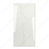 Calacatta Bianco glossy marble effect porcelain tile 60x120cm with 9mm thickness features bold veining and a refined polished finish for luxury spaces.