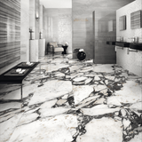  Impect Statuario 120x240cm glossy tile with bold grey veining on a white base. Perfect for luxury walls and floors with a timeless marble look.

